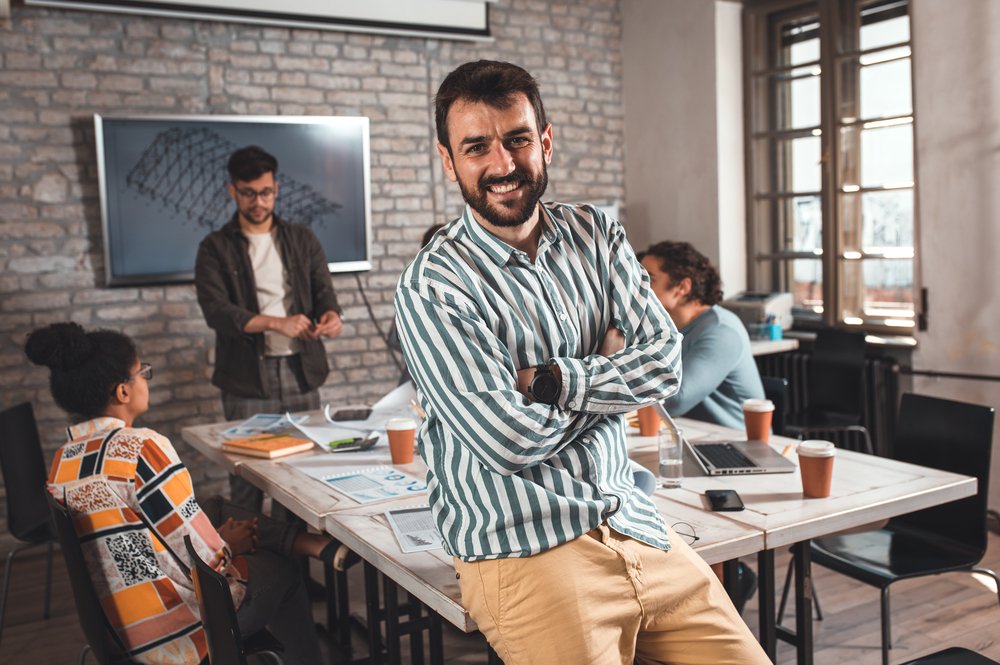 The Secrets Behind Successful Branding Agencies: Case Studies and Insights portrait of confident young male leader standing in office.