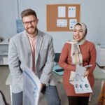 How to Choose the Right Branding Agency for Your Brand Vision three happy young intercultural colleagues looking at female economist